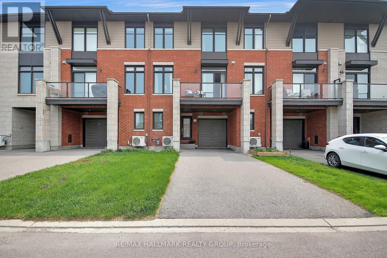 Welcome to 576 Labrador Crescent, a beautifully designed 'Ashton-A(Rev) gallery townhome by Tamarack Homes, located in the desirable community of Findlay Creek. This former model home boasts 9-foot ceilings on the first and second floors. The open-concept living and dining areas offer rich hardwood floors, while the modern galley-style kitchen is equipped with granite countertops, ample cabinetry and a walk-in pantry. A private balcony overlooks open backyards of non-direct neighbours, facing southwest, comes complete with a natural gas BBQ hookup, ideal for your seasonal enjoyment. This stylish home features two spacious bedrooms, including a primary suite with a walk-in closet that leads to an ensuite bath, and features a second full 4-piece bathroom. Additional highlights include an upper-level laundry room, an attached garage with an inside entry, pot lights, a security system, built-in speakers, upgraded interior door style, upgraded carpeting and underpad, and ample storage in the lower-level furnace room. Nestled in a family-friendly neighbourhood with parks, trails, schools, and shopping nearby, this home combines suburban tranquillity with urban convenience, making it an excellent choice for first-time buyers, downsizers, and investors. All appliances are included! Just move in and enjoy! Don't miss the opportunity to make this beautiful move-in-ready home! (id:48254)