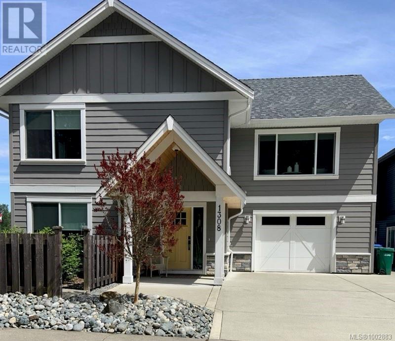 1308 Fielding Road Nanaimo, British Columbia Immaculate and move-in ready, this like-new home is located in the peaceful Blue Heron Landing neighbourhood near the Nanaimo River Estuary. Situated on a sunny corner lot on a quiet no-thru road, this 4-bedroom, 3-bathroom home offers 1,943 sqft of thoughtfully designed living space and remains covered under home warranty. Step inside to find high-quality finishes throughout. The open-concept main floor showcases wide-plank flooring, an electric fireplace for cozy evenings, and custom blinds to perfectly filter natural light. The gourmet kitchen is a true standout, featuring quartz countertops, a large island with breakfast bar, farmhouse sink, and timeless white shaker cabinetry. Sliding doors off the dining area lead to a sun-drenched deck, ideal for morning coffee or evening BBQs. Two well-sized bedrooms, a 4-piece bath with quartz counters, and a spacious primary suite complete the main level. The primary offers a large closet and a bright ensuite with quartz counters and sleek fixtures. All bedrooms are equipped with blackout blinds for restful sleep and added privacy. The lower level is equally functional and flexible, offering a fourth bedroom (or home office), a full bathroom, rec room, laundry, storage, and interior garage access, perfect for teens, guests, or extended family needs. Outside, enjoy a private, low-maintenance backyard oasis featuring a custom stamped concrete patio and a stylish gazebo, ideal for entertaining or relaxing year-round. A level driveway and attached garage provide convenience and ease of access. Located just minutes from Chase River amenities, downtown Nanaimo, the ferry, and the airport, plus with estuary trails just steps away, this home offers a perfect blend of quality, comfort, and connection to nature. Measurements and data are approximate and should be verified if important. (id:48254)
