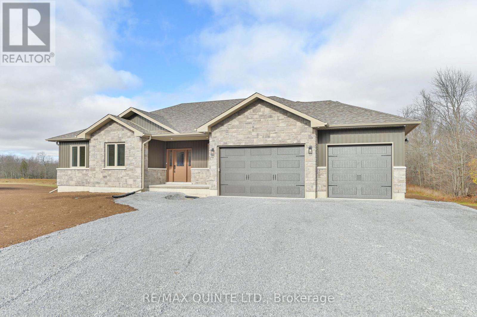 Craving privacy and rural bliss? Turn the key to your next custom built dream home. Newly constructed and built with pride by Voskamp Contracting Ltd. Quick closing easily accommodated. Offering approx 1794 sq ft on main level situated on 1.36 acres. Covered front porch leads to spacious foyer. Mindfully designed to entertain and for family function with open concept living. Great room showcases stunning feature wall complete with fireplace surrounded by floating shelves, enhanced with vaulted ceiling with potlights. Dining area with access to elevated 16' x 12' covered deck with pastoral views. Show-stopping kitchen with oversized island, finished pantry, abundance of cabinets all with quartz counters. Primary bedroom in its own wing with walk-in closet, 3pc ensuite. 2 additional bedrooms, one with walk-in closet, 4-pc bath, main floor laundry. Lower level with interior additional entry from oversized 28' x 23' double car garage is waiting for your finishes. Potential for in-law suite is an easy consideration. Efficient and economical heating with upgraded insulation. Tarion warranty. Superior quality. Centrally located between Campbellford (14 min) & Stirling (16 min). (id:48254)