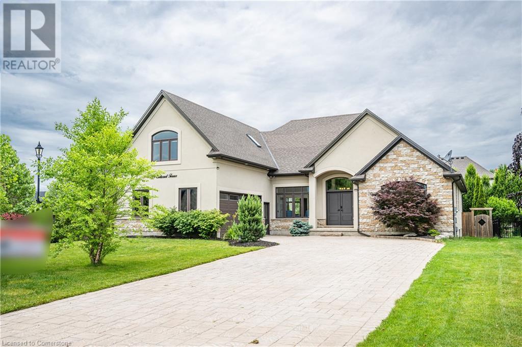 39 Earlscourt Terrace Komoka, Ontario Welcome to 39 Earlscourt Terrace, Kilworth – a custom-built bungaloft located beside Komoka Provincial Park and the Thames River. This home offers over 5,000 sq ft of finished living space, with 5 bedrooms (3 with private ensuites above ground) and 4.5 bathrooms. The open-concept living room has a 14-foot cathedral ceiling, oversized windows, a gas fireplace, built-in speakers, and hardwood floors. The kitchen includes custom cabinetry, granite countertops, stainless steel appliances with gas stove, built-in oven and microwave, a large breakfast bar, and stone backsplash. The adjacent dining area opens to the backyard through a walkout. The backyard is fully fenced and landscaped with mature trees, shrubs, mulched gardens, and space for a future pool. A covered concrete patio includes built-in speakers and pot lights. The main-floor primary bedroom has a walk-in closet and a 5-piece ensuite with double vanities, a glass-enclosed shower, and lighted mirrors. An upgraded floating staircase leads to the upper loft, which includes a home theatre system with surround sound and projector. It has a full bathroom and can function as a bedroom. The finished basement has 2 bedrooms, a large recreation room with a wet bar, mini-fridge, and electric fireplace, as well as a spa-like bathroom with soaking tub and glass shower. Includes oversized windows, storage, and a large cold room. The driveway fits 8–10 vehicles. The extended-sized two-car garage includes interior door entry. Close to schools, shops, and amenities like tennis courts, soccer fields, baseball diamonds, and a community center with YMCA, skating rink, library, gym, and splash pad. (id:48254)