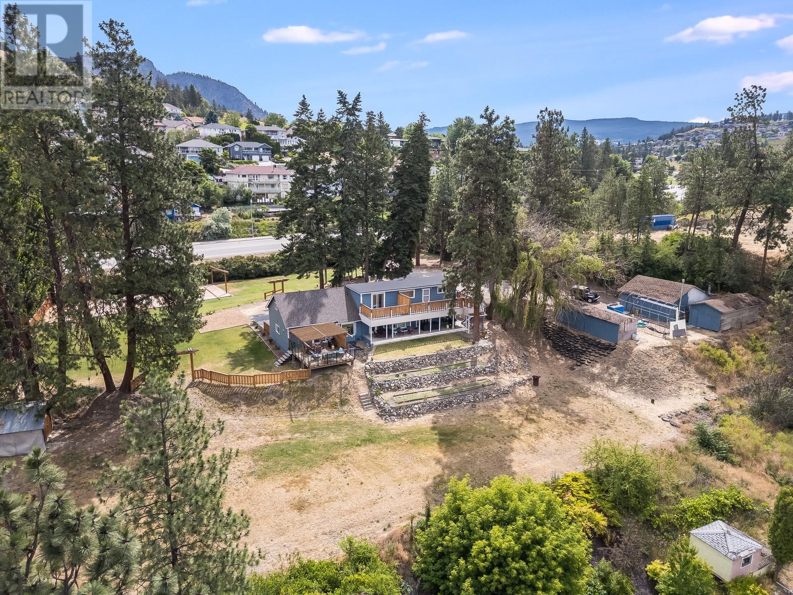1293 Highway 33 Other East Kelowna, British Columbia Once you see these views, nothing else will compare.Perched above the city on a rare, flat 1.80-acre gated lot, this one of a kind property offers jaw dropping, unobstructed views of the lake and city that stretch for miles. The 4-bed, 3-bath main home has been tastefully updated and is flooded with natural light—you’ll rarely need to flip a switch. The one bedroom and den suite is smartly laid out and lives like a half-duplex—no shared ceilings, and yes, it has its own incredible views too. Hosting? ALR zoning allows up to 10 events annually, making it turn-key for weddings events and more.This property is a dream for entertaining with endless parking, a detached shop, and plenty of space for large groups. Entrepreneur or business owner? If your business is growing and you’re running out of space for work vehicles, equipment, or staff—this solves it all. Say goodbye to paying for rent for storage and hello to parking space and storage galore. Better yet, the home is ideal for housing employees or tenants—helping cover your mortgage while keeping your team close. All of this tucked away in total privacy,yet only 10 minutes to the airport,minutes to groceries and restaurants,and 20 minutes to the beach.Properties like this—views, land, location, and versatility—are incredibly rare. Don’t miss your chance to own one of the most unique opportunities in the Okanagan. (id:48254)