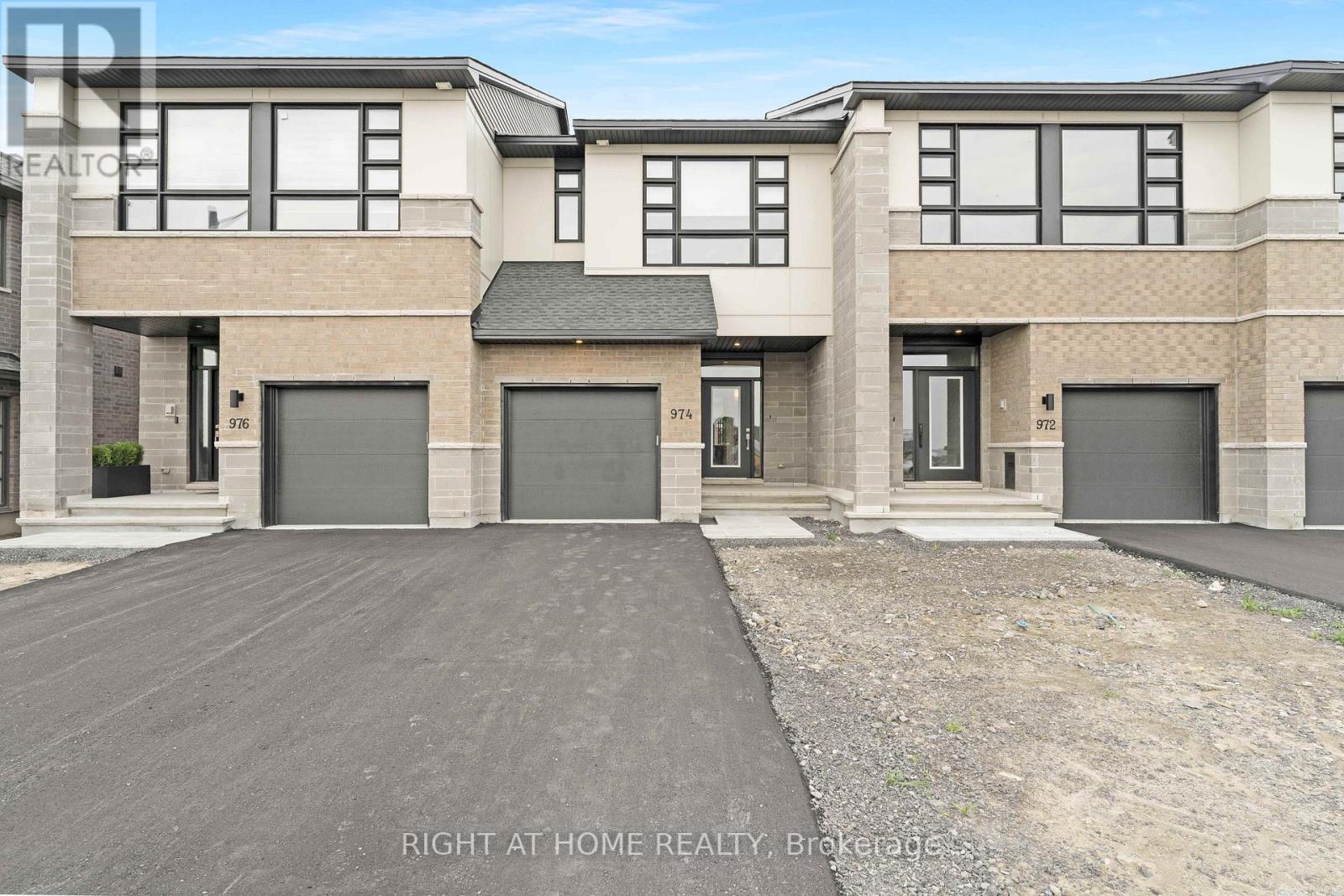 974 Acoustic Way Ottawa, Ontario Welcome to 974 Acoustic Way, a stunning executive townhome nestled in the highly sought-after Riverside South community. Built in 2023 by Urbandale Construction, this 2,000 sq. ft. Apollo model offers thoughtfully designed living space and is fully upgraded, making it move-in ready.The open-concept main floor features a stylish and functional kitchen with pot and pan drawers, a microwave hood fan, and a generous island overlooking the dining and living areas. A cozy gas fireplace adds warmth and ambiance to the spacious living room, perfect for entertaining or relaxing with family. Upstairs, the primary suite boasts a walk-in closet and an ensuite to die for. Two additional well-sized bedrooms, a full laundry room, and a versatile loft space ideal for a home office or kids play area complete the upper level.The fully finished lower level includes a full bathroom and offers the flexibility to be used as a home gym, movie room, or workspace. You're just steps away from a soon-to-be-completed community park, ideal for outdoor enjoyment. This home is a must-see and is sure to impress. Do not miss it! (id:48254)