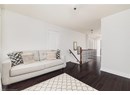 Living area with dark wood finished floors and baseboards