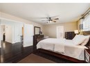 Bedroom featuring dark wood finished floors and a ceiling fan