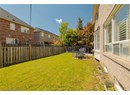 Fenced backyard with a patio area and a residential view