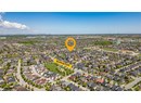 Aerial view of property and surrounding area featuring nearby suburban area