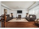 Living room featuring a textured ceiling, wood finished floors, and a fireplace