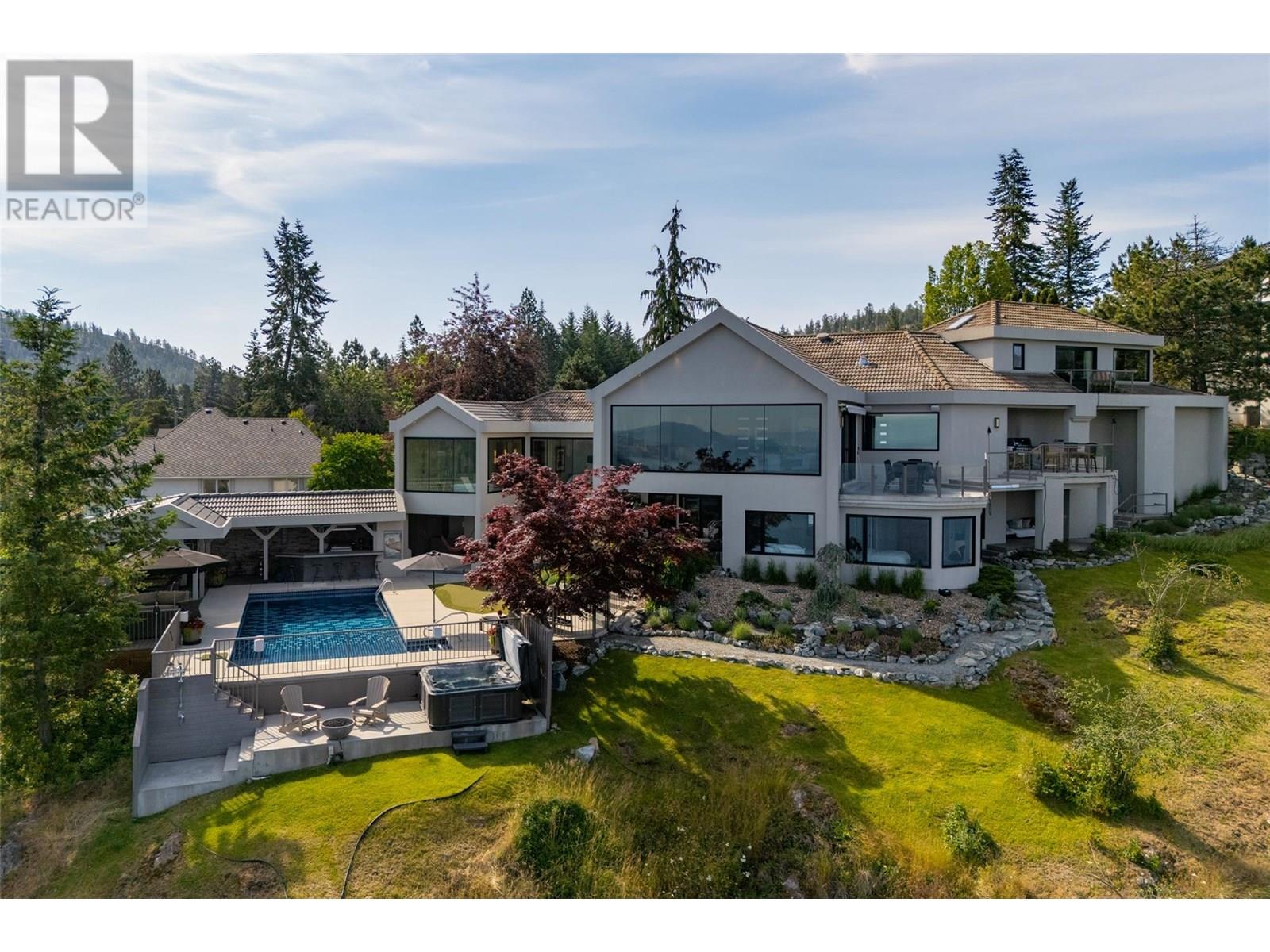 228 Caliburn Court Kelowna, British Columbia The Hideaway – Where Privacy, Nature, and City Life All Meet. $5.35M gets you the most breathtaking view in the valley—full stop. The Hideaway offers rare backyard privacy, bordering nothing but untouched nature—and direct access to one of Kelowna’s most scenic and sought-after parks. Over 5700 square feet across five levels of thoughtful design, natural light, and real living—centred around a 26 -foot wall of glass that turns the Okanagan into living art, and puts the entire valley on full display. From the chef’s kitchen to the gym, the terrace to the putting green, the games room to the pool deck—every space flows effortlessly into the next, built for real life, real fun, and total solitude when needed. Downtown is just ten minutes away. But up here? It feels like another world. The Hideaway has to be seen, felt and experienced to be appreciated. Enjoy the video. (id:48254)