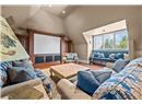 Lofted Entertainment Area Features a Theatre Setup