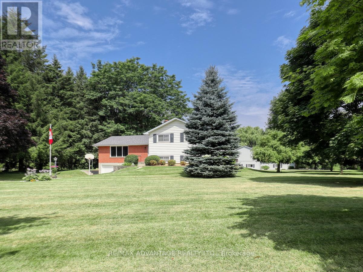 17248 Wyton Drive Thames Centre, Ontario A rare and scenic small acre hobby farm with a wonderful quality built home by its original owner. Approx 2.7 acres of rolling land with a stunning barn, 3 rows of tall evergreens, 2 paddocks, a small run in, 2 horse stalls and more. The barn encomapasses extensive storage areas, 2 possible mechanic/workshop areas (one access door is 10 x 12 ft) stall area ( water is at the barn) and a walk up to a lovely large attic space with Built in storage and two sections (one was used as a hay storage area with a drop access to the stall area). A sun filled home as you enter the front door into a large open entrance foyer with updated stair railings, beautiful hardwood flooring, formal living room with a pretty southerly view, separate dining room plus an eat in kitchen! 2 oversized bathrooms, a spacious yet cozy feeling family and games room areas on the third level. Family room with large windows, wood burning fireplace and a walk out to enclosed sunroom on that same level. Ample parking spaces, 2 car garage with inside entry to a mudroom. Geothermal Heating/Cooling, Updated shingles, windows (various years), central vacuum. A quiet road close to the Thorndale community, parks and easy access to Trails End Market, Heemans, Golf courses and a hop skip and a jump into London. (id:48254)