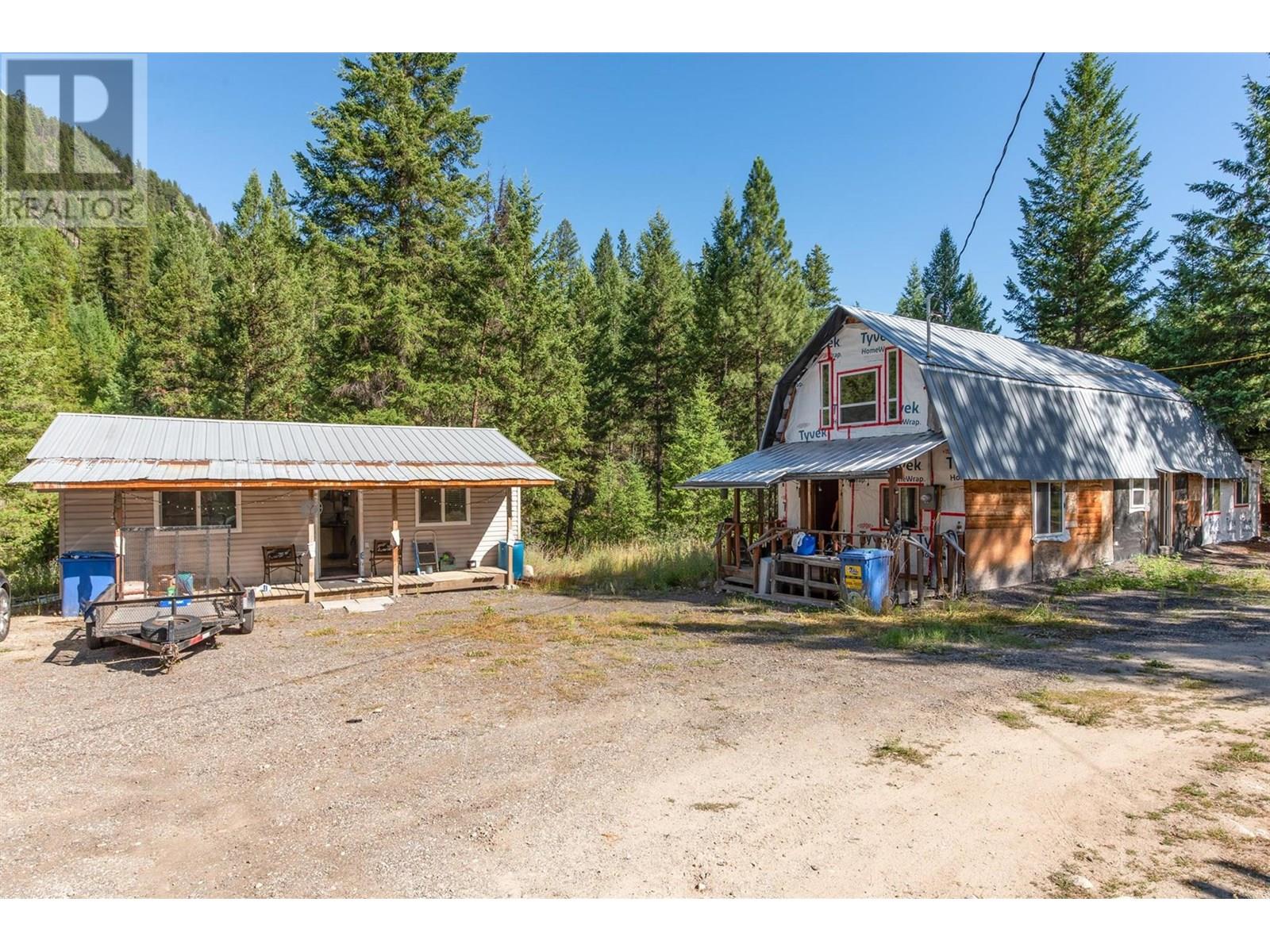 A True Diamond in the rough! Bring your ideas and convert this property into an awesome recreational getaway, and subdivide off the back 5 acres and still have tons of space and privacy. NOTE... ALL BUILDINGS ARE BEING SOLD ""AS IS - WHERE IS"". Between the main cabin and the guest house, there is nearly 2000 sq. ft. of livable space. It is serviced by 200 amp Electric Service, a well providing potable water and functioning sewage system. Just 8 kms to the town of Beaverdell, this property is uniquely situated to enjoy all outdoor sports. There are trails, streams, lakes and so much more. The former Kettle Valley Railway, part of the Trans-Canada Train is just a couple of kms away. A fishing lake is within a 5 minute drive. and you could spend a lifetime exploring the various trails in the area. The ""back side"" of the property is bordered by Beacon Road. It woud be easy to create an entirely independent 5 acre property, with its own road access and still maintain the peaceful privacy this property offers. (id:48254)