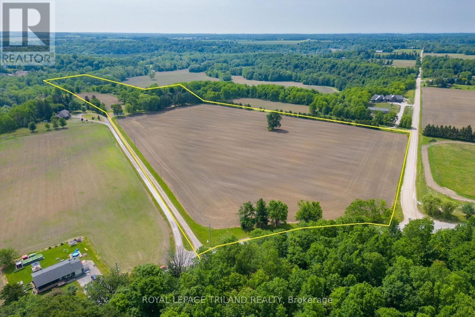 39339 Bush Line St. Thomas, Ontario Rare chance to own 26.5 picturesque acres on Bush Line within St. Thomas boundaries just 5kms from downtown with easy access to London, Port Stanley & Hwy 401. The property features approx. 17 acres of workable farmland and 9 acres of woods, ravine and land surrounding a spacious 6-bedroom, 2-bathroom brick ranch and two outbuildings set back off the road. A long private driveway leads to the original-owner brick ranch, nestled among mature trees with scenic ravine views in the backyard. With over 2,000 sq. ft. above grade, this home offers space and flexibility with its unique sprawling layout ideal for updating, personalizing, or accommodating multi-generational living. It features 6 bedrooms, 2 full baths with two sets of front and backyard door accesses, and two stairwells to the separated lower levels with many large windows. There are 2 furnaces and 2 water heaters. Outbuildings include a shed, a 19 x 26 garage with hydro, concrete floors, and a loft, plus a 20' by 26' workshop. Enjoy peaceful country living without sacrificing city convenience; your rural dream is close to everything. (id:48254)