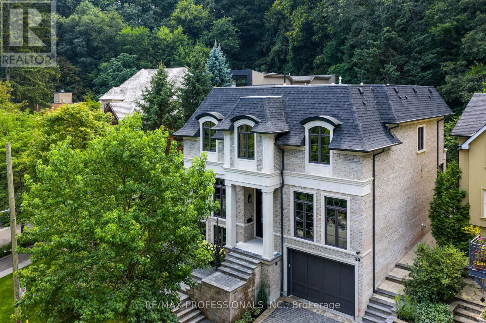 Nestled on a quiet cul-de-sac in a rare, beautiful ravine setting, this 5,000+ sq ft French-inspired estate architecturally refined by Hausworks, built by Atelier Custom Homes and designed and styled by Rizo Lola Designs offers three levels of refined luxury built with the finest curated materials. The main floor features a formal dining room, elegant office, and a stunning open-concept kitchen and family room with high-end appliances, honed quartzite & marble countertops, custom fine cabinetry, a large center island and a breakfast nook with ravine views. The family room, anchored by a limestone fireplace, flows into a sunroom overlooking the ravine. Upstairs boasts four spacious bedrooms, including a serene primary retreat with a grand walk-in closet and spa-like ensuite with oversized glass shower and heated floors. The lower level offers a wine room, wet bar, rec room with fireplace and custom built-ins, radiant heating, a fifth bedroom/office, full bath with steam shower, and gym. The exterior blends aged brick with limestone, professionally landscaped grounds, cobblestone driveway with snowmelt system, Generac generator, custom stone patio/walkway, and in-ground irrigation. Situated on an impressive ravine lot in one of the city's most prestigious enclaves, close to top schools, parks, and major routes, this residence delivers unmatched privacy, elegance, and lifestyle for the most discerning buyer. (id:48254)