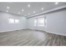 Spare room with plenty of natural light, recessed lighting, baseboards, and wood finished floors
