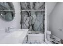 Full bathroom featuring vanity, baseboards, combined bath / shower with glass door, toilet, and marble finish floor