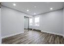 Unfurnished bedroom with wood finished floors, baseboards, recessed lighting, a closet, and baseboard heating
