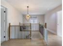 Stairway featuring a chandelier, wood finished floors, and recessed lighting