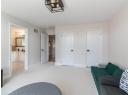 Sitting room featuring light carpet and baseboards