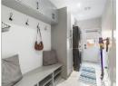 Mudroom featuring stacked washer and clothes dryer and light marble finish floors