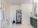 Bathroom with marble finish floors and vanity