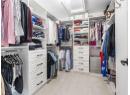 Spacious closet with attic access and light carpet