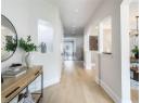 Hallway with light wood-type flooring, recessed lighting, stairway, and a chandelier