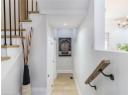 Corridor featuring light wood finished floors, a chandelier, stairs, and recessed lighting
