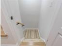 Stairway with wood finished floors and baseboards