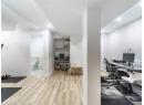 Office with wood finished floors and recessed lighting