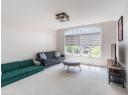 Living area featuring carpet flooring and vaulted ceiling
