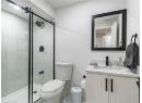 Full bathroom featuring vanity and a marble finish shower