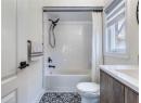 Bathroom featuring shower / bath combo, vanity, and tile patterned flooring