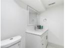Bathroom with marble look tiles and vanity