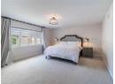 Bedroom featuring carpet floors and baseboards
