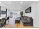 Living room with recessed lighting and light wood-style floors