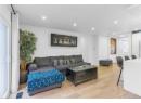 Living room with light wood-style flooring and recessed lighting