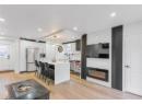 Kitchen with stainless steel appliances, light countertops, a breakfast bar, a kitchen island, and healthy amount of natural light