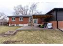 Back of house featuring brick siding