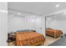 Bedroom with vaulted ceiling, light wood-type flooring, a closet, and recessed lighting