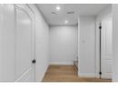 Corridor with light wood-style floors, recessed lighting, and stairs