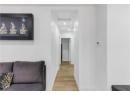 Corridor with wood finished floors, attic access, and recessed lighting