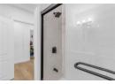 Full bath featuring a shower and wood finished floors