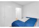 Bedroom with light wood-style flooring and baseboards