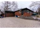 View of front facade with entry steps, decorative driveway, and brick siding