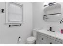 Full bathroom with vanity and a shower with shower door