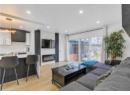 Living area featuring light wood-type flooring, recessed lighting, and a fireplace