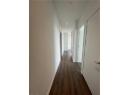 Corridor with dark wood-style flooring and recessed lighting