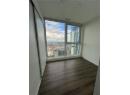 Empty room with a city view and dark wood-type flooring