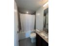 Bathroom with shower / tub combo with curtain, vanity, and tile patterned floors