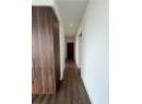 Hall featuring dark wood-style flooring and recessed lighting
